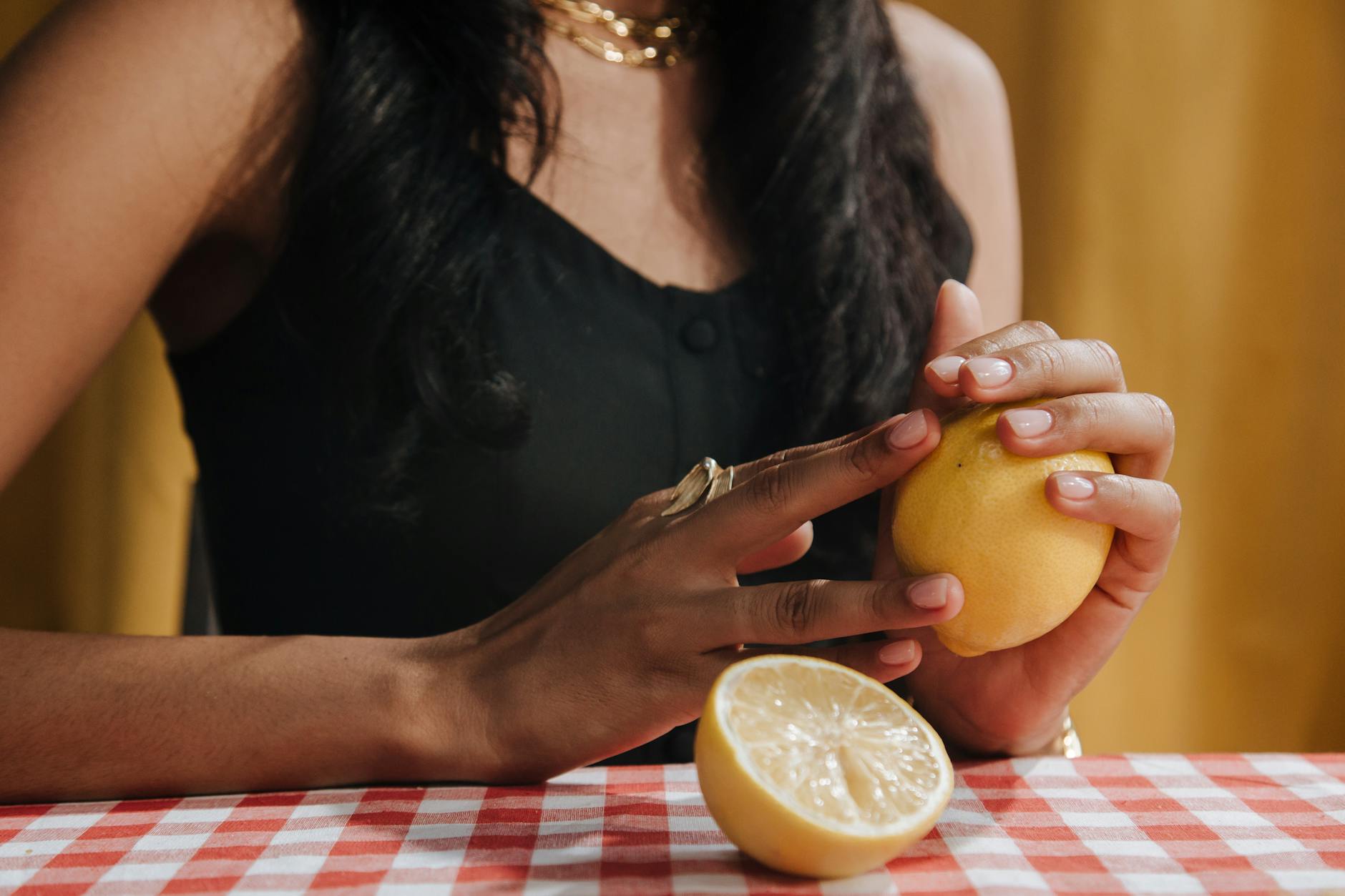 Bright yellow lemons arranged on a pastel green background, representing the lemon vibrator product line