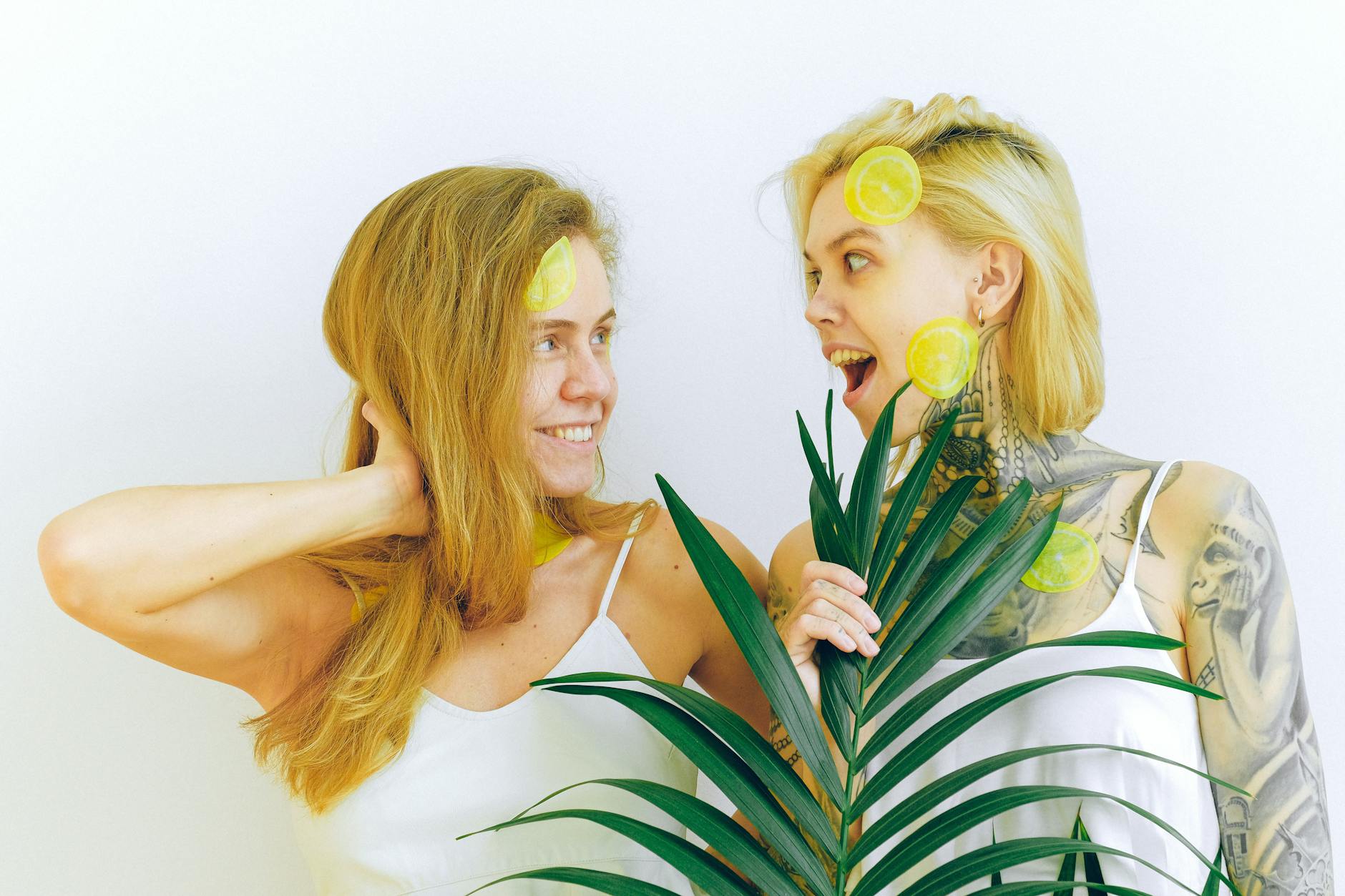 Two women smiling and laughing together indoors, expressing joy and connection