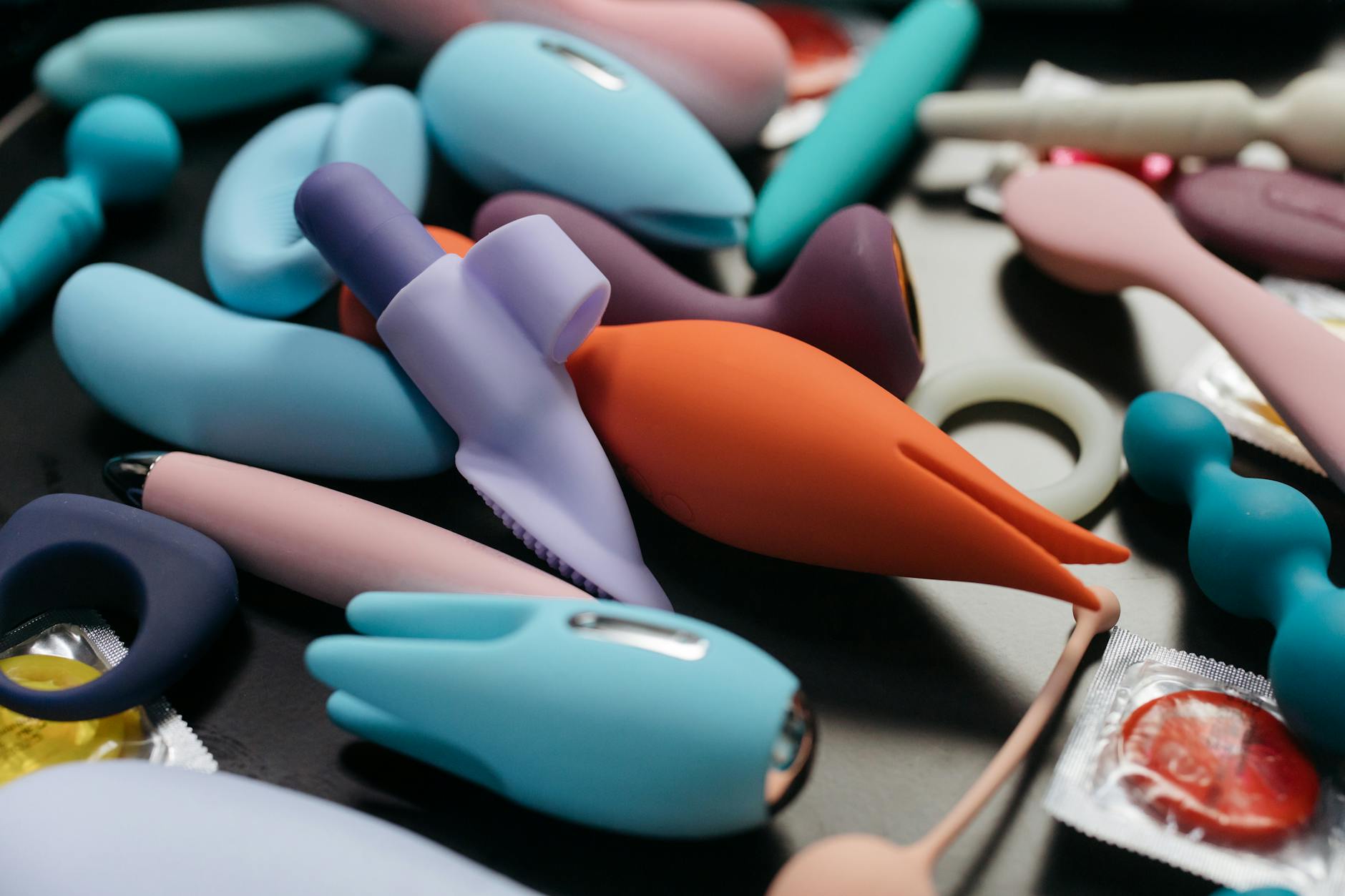 Array of colorful vibrators and intimate wellness toys displayed together