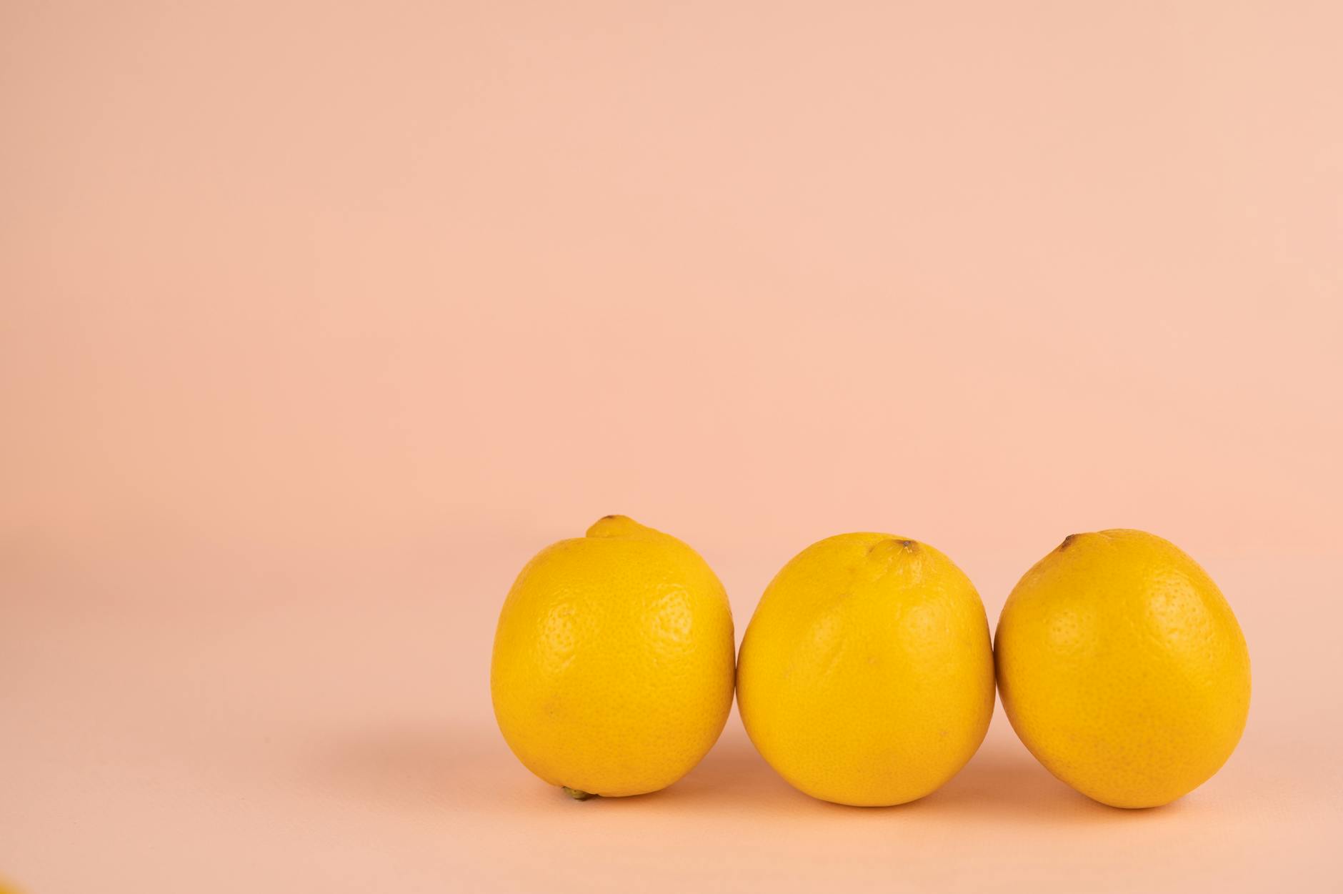 Bright yellow lemons arranged on a pastel background representing the gentle, approachable design of beginner-friendly lemon vibrators